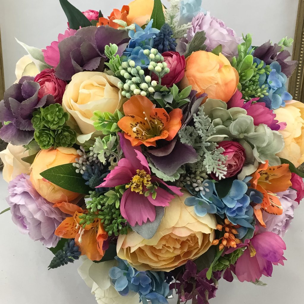 artificial silk flower bridal bouquet, hand tied posy style. vibrant . orange, cerise, green, ivory, blue purple lime. inc roses, peony, alstromeria, berry, hydrangea, lambs ear, succulent & ivy