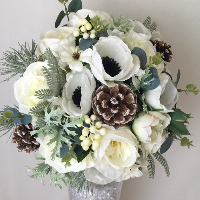 artificial silk flower bridal bouquet, ivory, white, natural, green. hand tied posy style bouquet, seasonally inspired, inc anemone, berries, roses, silver, grey foliage cones, mixed fir cones