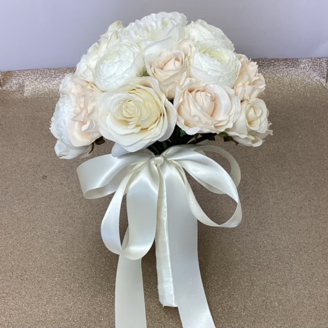 artificial silk flower brides bouquet. compact hand tied style. p pastel colours, apricot, cream, ivory ,available in most colours , peony, roses & ranunculus,