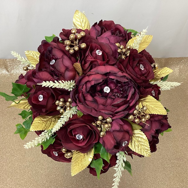 arti8ficial silk flower brides bouquet, hand tied posy style compact in design. burgundy, gold, ivory &,green. inc peony, roses, gold leaves, berries astilbe & ivy