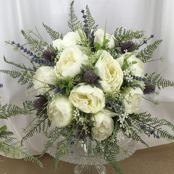 artificial silk flower brides bouquet, hand tied posy style. loose fairly open design.. ivory, blue, lavender. inc peony, thistle, fern, berry, ruscus, lavender thistle & meadow grass