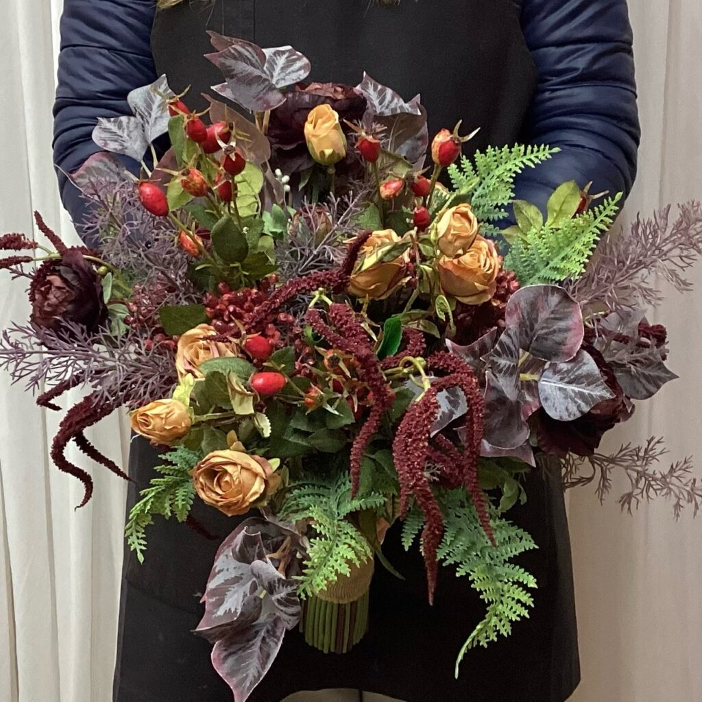 artificial silk flower bridal bouquet, loose open natural hand tied posy. autumnal inspired, woodland , inc eucalyptus, fern, rosehip, amaranthus, , berries, spray roses, ranunculus, dill
