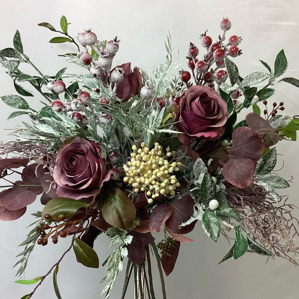 large artificial silk flower bridal bouquet. natural loose hand tied posy style. burgundy, reds, brown, green. inc roses, rosehips, white frosted berry, limonium, berried greenery, ivory berry. & eucalyptus