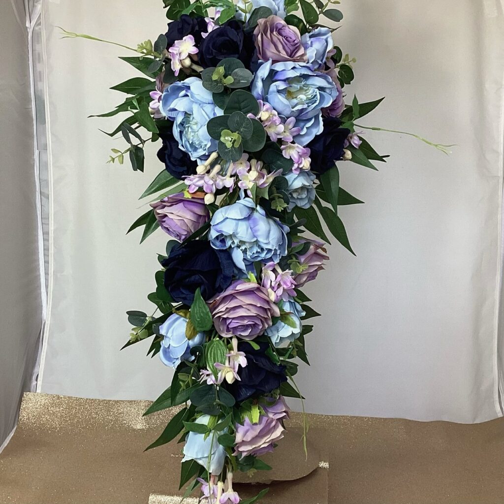 The Rosie Artificial Brides teardrop bouquet in Navy Roses, blue Peony and lilac Stephanotis